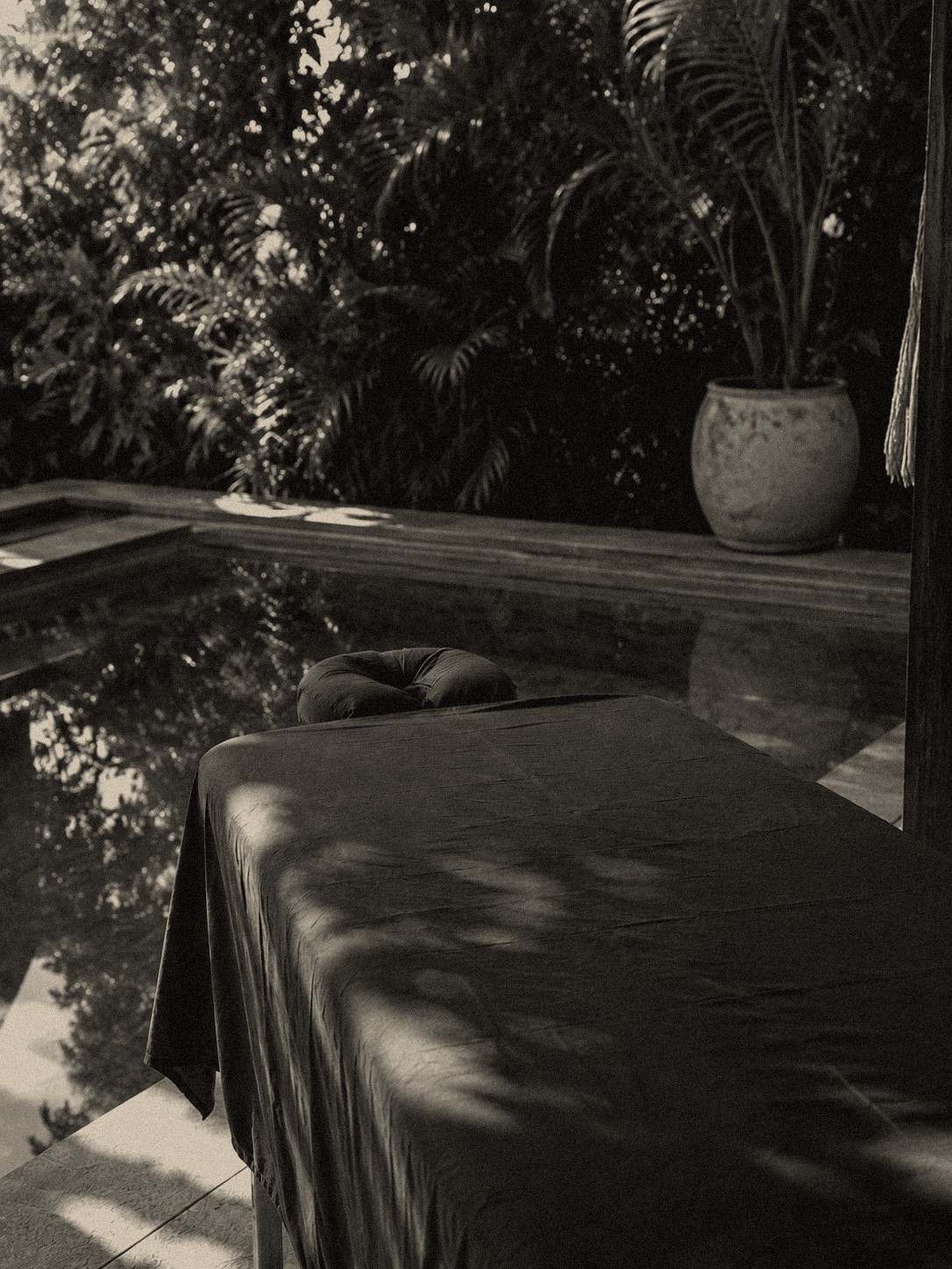 A massage table set up poolside in a villa