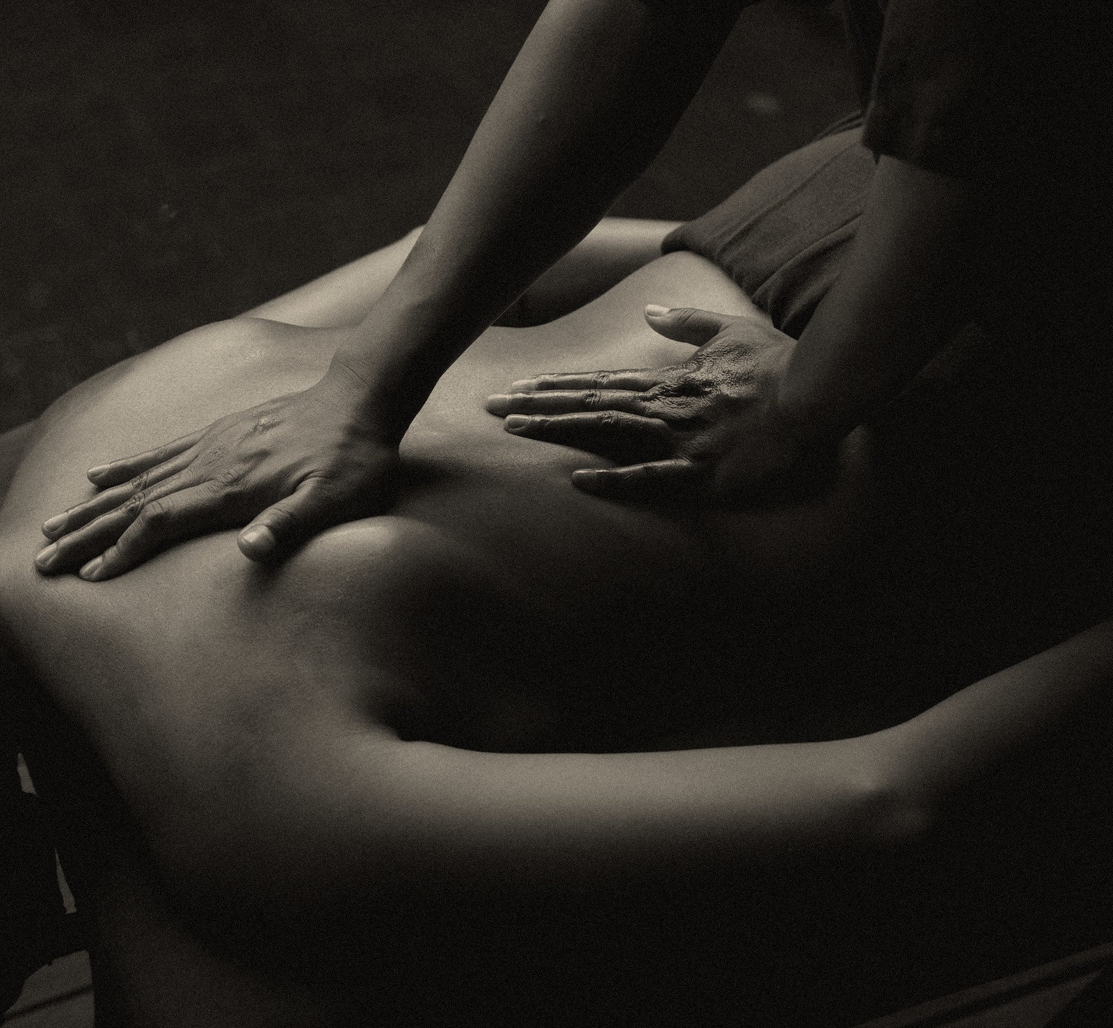 Hands performing a traditional Balinese back massage