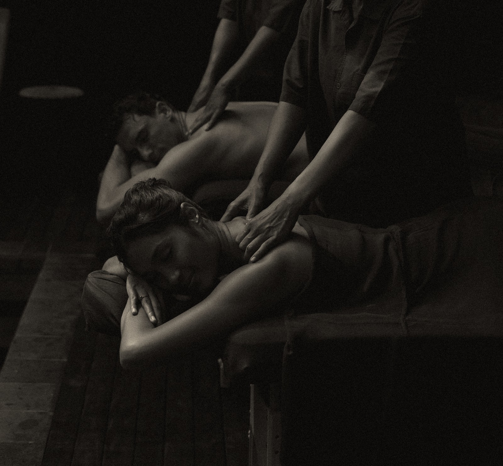 Two guests receiving a side-by-side couples massage